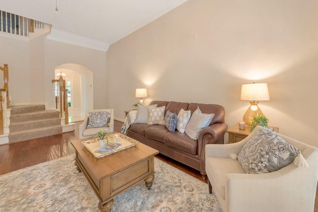 126 S Bluff Creek Cir, The Woodlands, TX 77382 - living room with arched walkways, wood finished floors, stairway, and crown molding