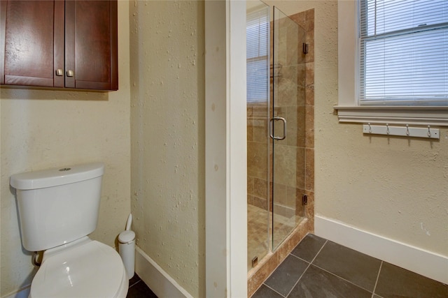 239 Westheimer Rd, Houston, TX 77006 - full bathroom featuring toilet, a stall shower, and tile patterned flooring