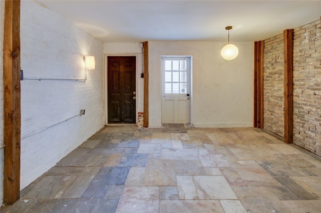 239 Westheimer Rd, Houston, TX 77006 - foyer entrance with stone tile flooring and brick wall