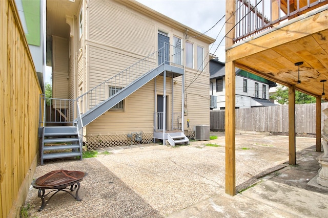 239 Westheimer Rd, Houston, TX 77006 - rear view of property featuring an outdoor fire pit, a balcony, cooling unit, a patio, and a ceiling fan