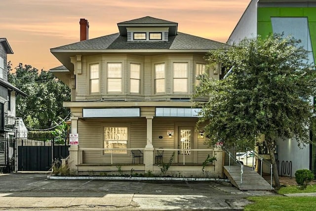 239 Westheimer Rd, Houston, TX 77006 - traditional style home featuring a porch, roof with shingles, and a chimney