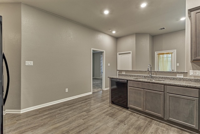 14208 Sedona Ridge Dr, Conroe, TX 77303 - kitchen with dishwashing machine, light wood-style floors, recessed lighting, light stone countertops, and a peninsula
