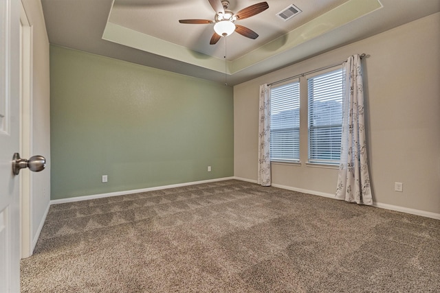 14208 Sedona Ridge Dr, Conroe, TX 77303 - unfurnished room with a tray ceiling, carpet flooring, and ceiling fan