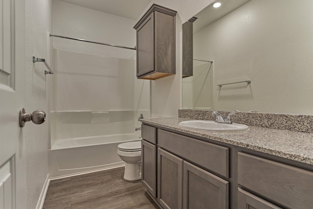 14208 Sedona Ridge Dr, Conroe, TX 77303 - bathroom featuring vanity, shower / bathtub combination, wood finished floors, and a textured wall