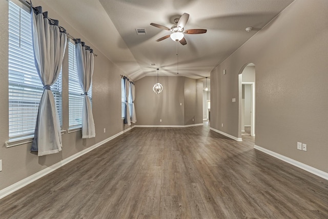 14208 Sedona Ridge Dr, Conroe, TX 77303 - empty room with arched walkways, a ceiling fan, dark wood finished floors, and vaulted ceiling