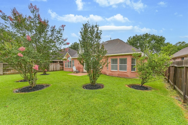11510 Amber Canyon Dr, Houston, TX 77095 - rear view of property with a fenced backyard, brick siding, a patio area, and a shingled roof
