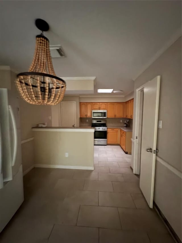 18530 Denise Dale Ln, Houston, TX 77084 - kitchen featuring stainless steel appliances, light brown cabinets, light countertops, light tile patterned floors, and a chandelier