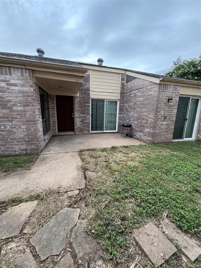 18530 Denise Dale Ln, Houston, TX 77084 - rear view of house featuring a patio area, brick siding, and a yard