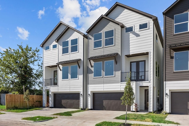 1711 Bardwell St, Houston, TX 77009 - view of front of home with a garage, driveway, a balcony, and french doors
