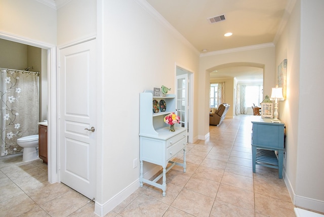 235 Ranch House Ln, Richmond, TX 77469 - corridor featuring arched walkways, crown molding, light tile patterned flooring, and baseboards