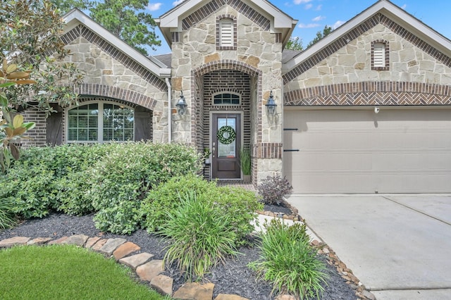 138 Verismo Ct, Montgomery, TX 77316 - view of front of house with stone siding, concrete driveway, and a garage
