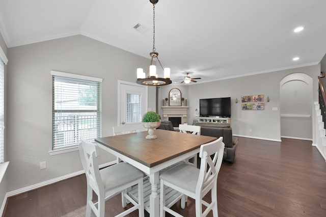 138 Verismo Ct, Montgomery, TX 77316 - dining space with a fireplace, ceiling fan, dark wood finished floors, a chandelier, and stairway