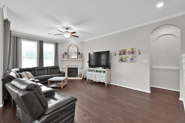 138 Verismo Ct, Montgomery, TX 77316 - living room featuring ceiling fan, dark wood-type flooring, ornamental molding, a glass covered fireplace, and arched walkways