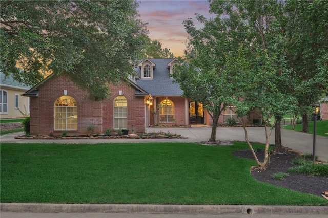 16 Waterberry Way, Montgomery, TX 77356 - view of front of home featuring brick siding, a yard, roof with shingles, and driveway