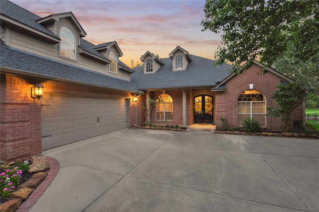 16 Waterberry Way, Montgomery, TX 77356 - view of front of property with brick siding, concrete driveway, a shingled roof, french doors, and a porch
