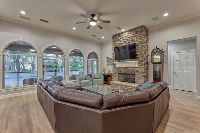16 Waterberry Way, Montgomery, TX 77356 - living area with ceiling fan, crown molding, a stone fireplace, light wood-style floors, and recessed lighting