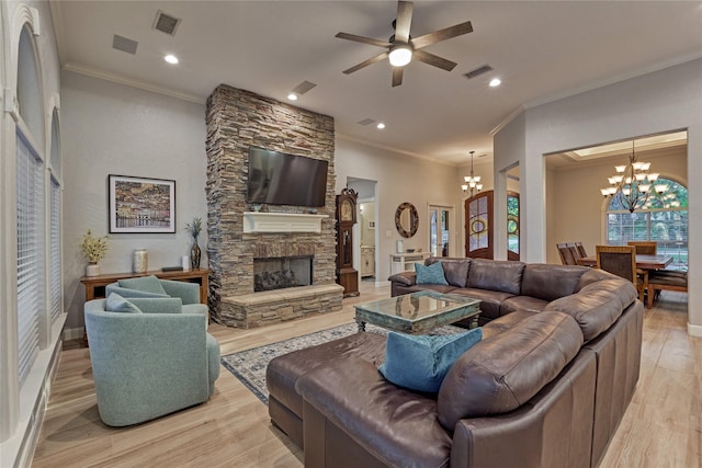 16 Waterberry Way, Montgomery, TX 77356 - living area with a chandelier, crown molding, a ceiling fan, light wood-style flooring, and a fireplace