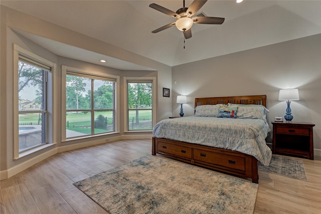 16 Waterberry Way, Montgomery, TX 77356 - bedroom featuring multiple windows, light wood finished floors, baseboards, recessed lighting, and vaulted ceiling
