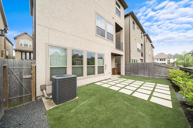 10812 Kyler Oaks Pl, Houston, TX 77043 - rear view of house with central AC unit, stucco siding, a residential view, and a patio