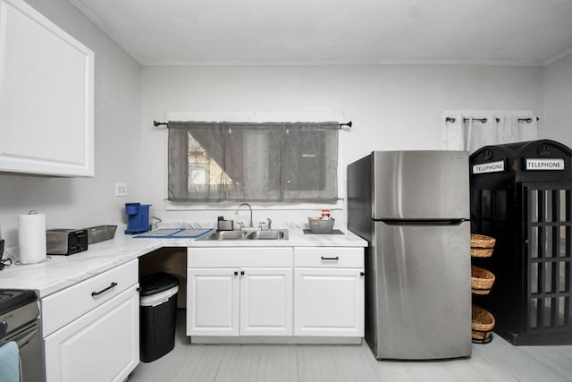 4409 Brady St, Houston, TX 77011 - kitchen featuring stainless steel appliances, white cabinets, light countertops, and light wood-style flooring