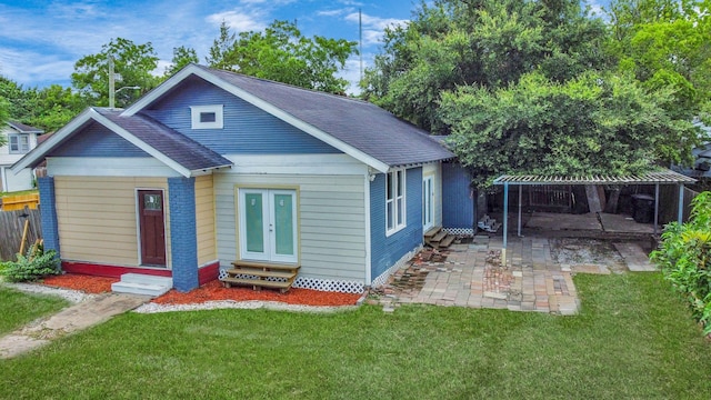 4409 Brady St, Houston, TX 77011 - bungalow with entry steps, a patio, a shingled roof, and french doors