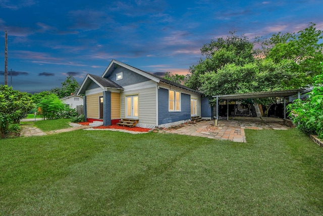 4409 Brady St, Houston, TX 77011 - rear view of property featuring entry steps, a yard, a carport, and a patio