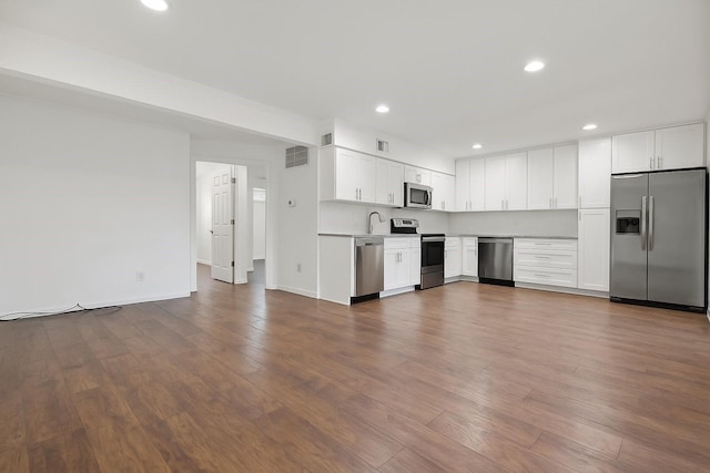 4723 Aftonshire Dr Unit A3, Houston, TX 77027 - kitchen featuring appliances with stainless steel finishes, white cabinets, dark wood-style flooring, recessed lighting, and light countertops