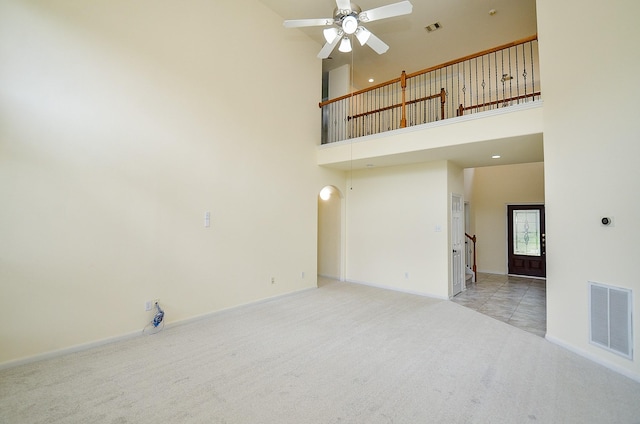 25314 Sandy Trace Ln, Katy, TX 77494 - unfurnished living room with carpet, ceiling fan, and a towering ceiling