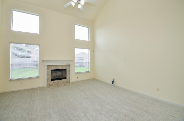 25314 Sandy Trace Ln, Katy, TX 77494 - unfurnished living room with high vaulted ceiling, ceiling fan, a tile fireplace, and light carpet