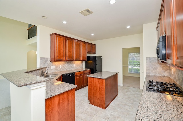 25314 Sandy Trace Ln, Katy, TX 77494 - kitchen featuring black appliances, a center island, light stone counters, recessed lighting, and a peninsula