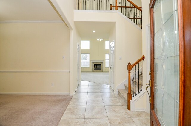 25314 Sandy Trace Ln, Katy, TX 77494 - entrance foyer with light carpet, a towering ceiling, stairway, light tile patterned floors, and a fireplace