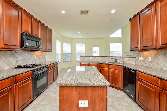 25314 Sandy Trace Ln, Katy, TX 77494 - kitchen with black appliances, a kitchen island, light stone countertops, tasteful backsplash, and recessed lighting