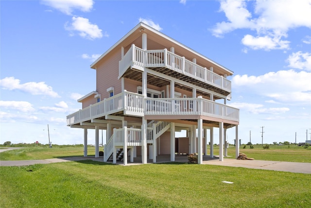 3101 Diane, Crystal Beach, TX 77650 - back of house with a lawn, a carport, a wooden deck, driveway, and stairs