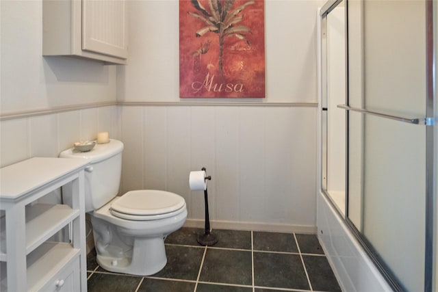 3101 Diane, Crystal Beach, TX 77650 - full bathroom featuring toilet, tile patterned flooring, wainscoting, shower / bath combination with glass door, and baseboards