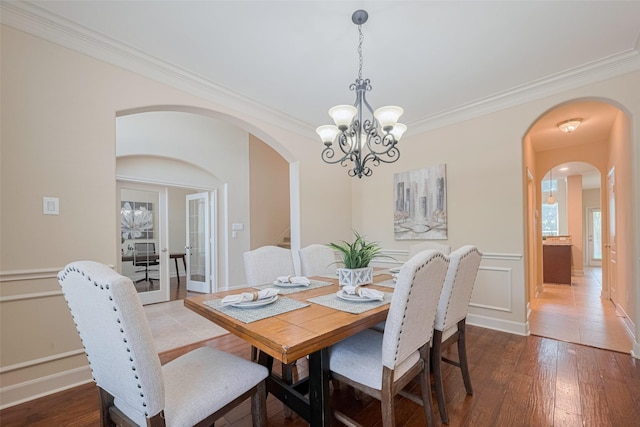4211 Turtle Trails Ln, Sugar Land, TX 77479 - dining area with arched walkways, crown molding, a chandelier, and wood finished floors