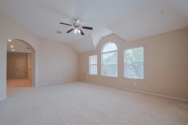 4211 Turtle Trails Ln, Sugar Land, TX 77479 - empty room featuring a ceiling fan, light carpet, arched walkways, baseboards, and vaulted ceiling