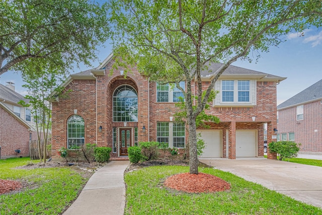 4211 Turtle Trails Ln, Sugar Land, TX 77479 - traditional-style home featuring brick siding, concrete driveway, an attached garage, and a front lawn