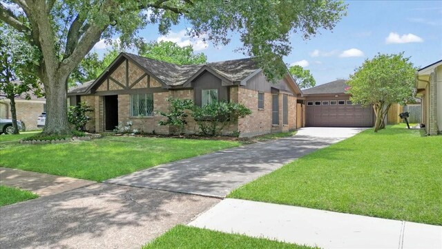 10518 Sageburrow Dr, Houston, TX 77089 - view of front of house with driveway, brick siding, a front yard, and an attached garage