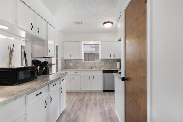 10518 Sageburrow Dr, Houston, TX 77089 - kitchen featuring dishwasher, black microwave, tasteful backsplash, white cabinets, and a textured ceiling
