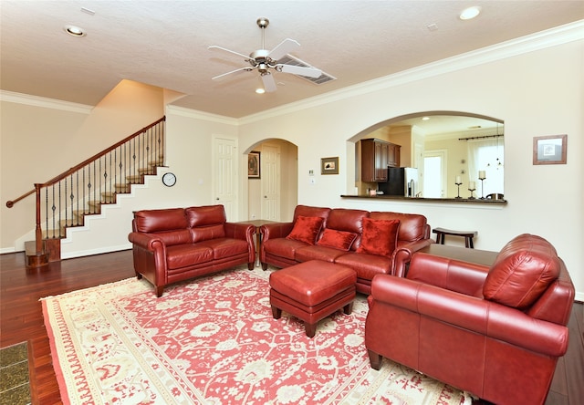 1226 Sopris Dr, Houston, TX 77077 - living room featuring ceiling fan, wood finished floors, ornamental molding, stairway, and arched walkways