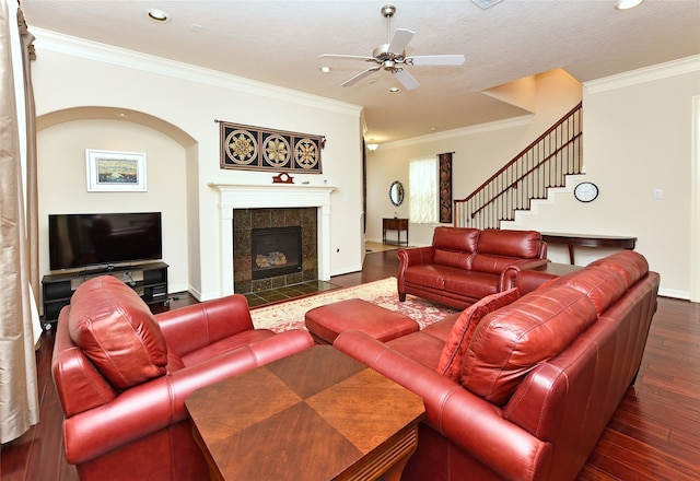 1226 Sopris Dr, Houston, TX 77077 - living area featuring dark wood-style floors, ornamental molding, recessed lighting, ceiling fan, and a tiled fireplace