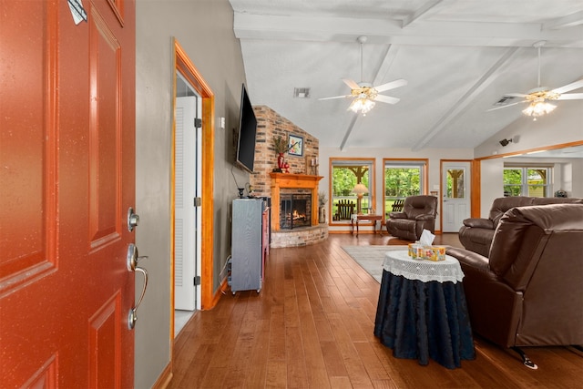 33315 Cripple Creek Dr, Pinehurst, TX 77362 - living room featuring hardwood / wood-style flooring, a ceiling fan, a brick fireplace, beamed ceiling, and high vaulted ceiling