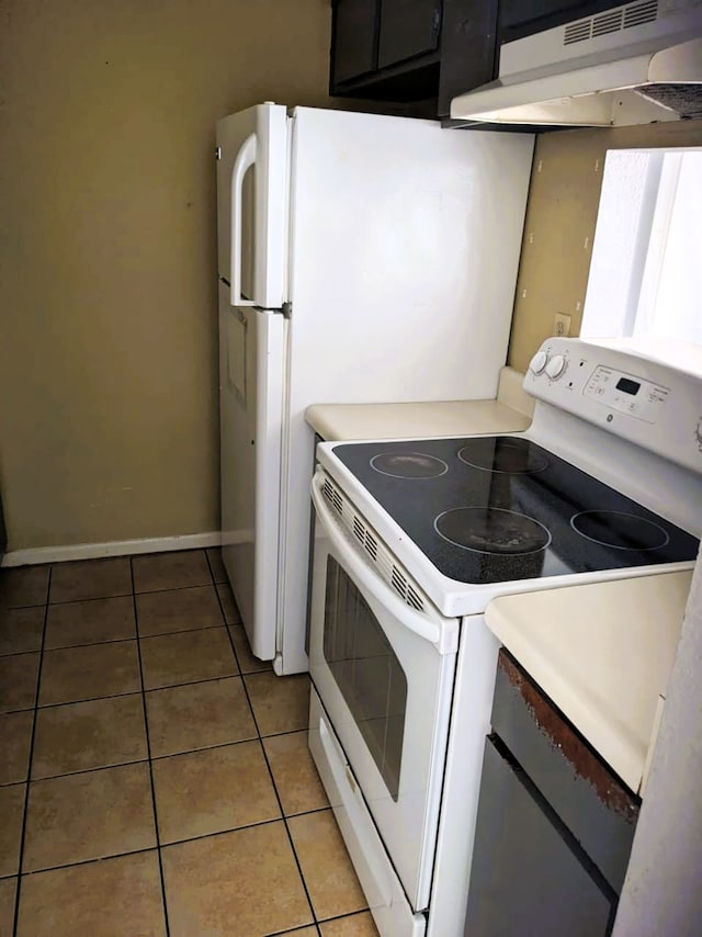8421 Hearth Dr Unit 21, Houston, TX 77054 - kitchen featuring white range with electric cooktop, under cabinet range hood, light tile patterned floors, and light countertops