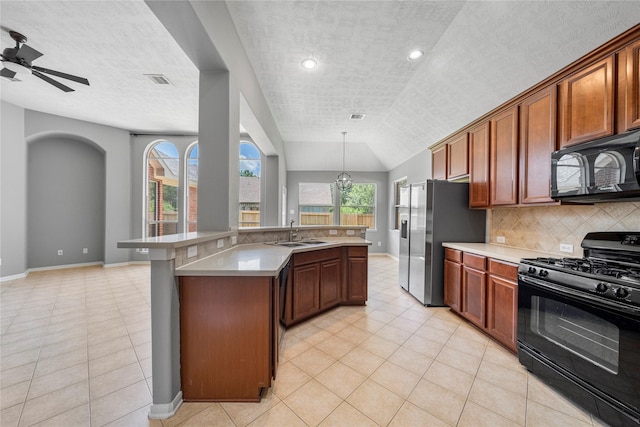 24910 Crystal Stone Ln, Katy, TX 77494 - kitchen featuring black appliances, plenty of natural light, light countertops, tasteful backsplash, and lofted ceiling