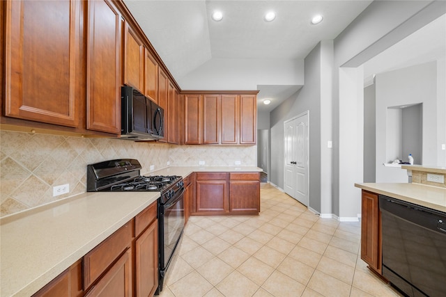 24910 Crystal Stone Ln, Katy, TX 77494 - kitchen with black appliances, light countertops, tasteful backsplash, lofted ceiling, and light tile patterned floors