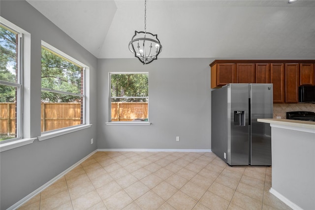24910 Crystal Stone Ln, Katy, TX 77494 - kitchen featuring stainless steel fridge with ice dispenser, a chandelier, lofted ceiling, range, and light countertops