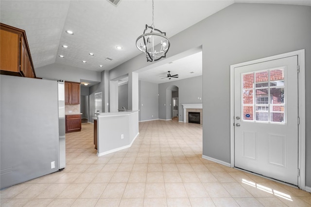 24910 Crystal Stone Ln, Katy, TX 77494 - kitchen with freestanding refrigerator, a chandelier, a ceiling fan, open floor plan, and a fireplace