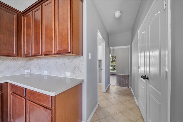 24910 Crystal Stone Ln, Katy, TX 77494 - kitchen featuring tasteful backsplash, light countertops, and light tile patterned flooring