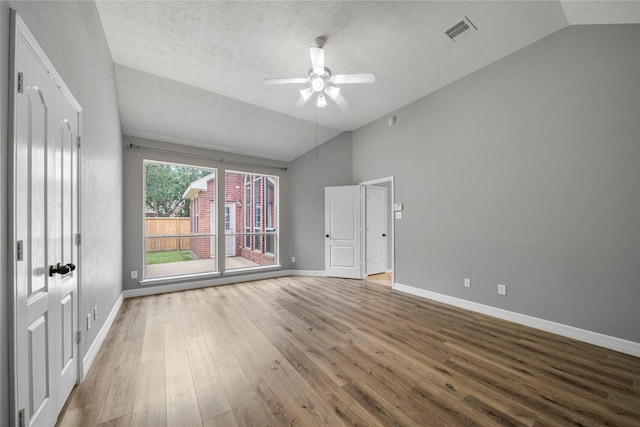 24910 Crystal Stone Ln, Katy, TX 77494 - empty room with lofted ceiling, wood finished floors, ceiling fan, and a textured ceiling
