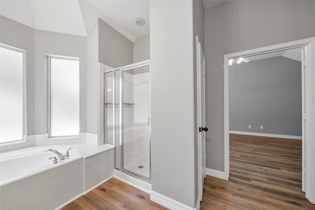 24910 Crystal Stone Ln, Katy, TX 77494 - bathroom with a stall shower, a bath, and wood finished floors